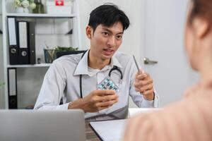 Patient Education and Medication Overview. Doctor elaborating on medication while showing a pill pack. photo