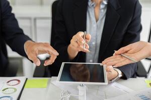 Collaboration and Digital Tools. Team members exchanging ideas using a tablet during a strategy meeting. photo