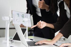 Renewable Energy Discussions and ESG Implementation. Focus on a collaborative strategy meeting for sustainable practices involving technology. photo