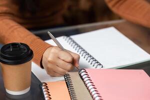 Note-Taking and Idea Development. A student diligently writing notes in a creative workspace. photo