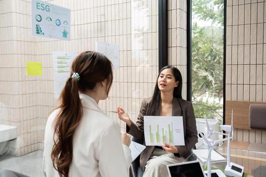 ESG Strategies and Dialogue. A professional discussion about ESG metrics and sustainable growth, featuring visual data charts. photo