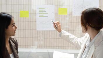 Data Analysis and ESG Evaluation. Two professionals review statistics on sustainable practices. photo