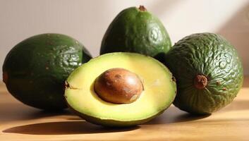 Fresh Avocados on Wooden Surface in Natural Light photo
