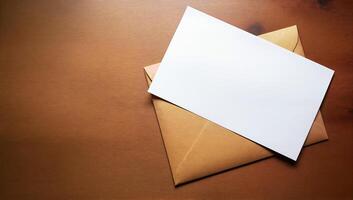 Blank White Paper and Brown Envelope on Wooden Table photo