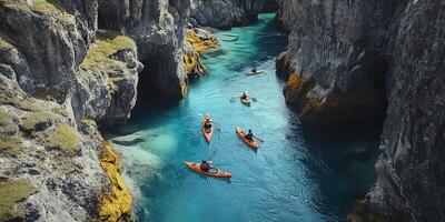 Aerial View of Kayaks on Turquoise Sea Between Cliffs in Sunlight Adventure Trip photo