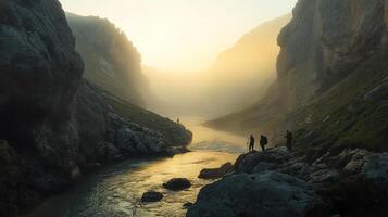 Hikers Amidst Rocky Mountains and River Valley Under Golden Sunrise with Foggy Mist and Sunlight photo
