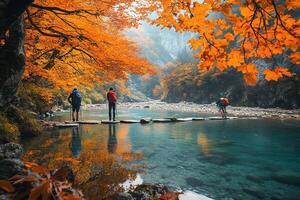 Hikers Crossing Tranquil Lake on Log Bridge Framed by Autumn Trees with Orange Foliage and Reflections Under a Bright Sky photo