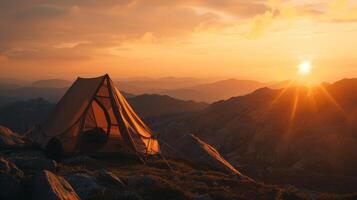 Golden Sunrise Over A Mountainous Landscape With A Lone Tent. photo