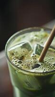 Refreshing Iced Matcha Latte with Bamboo Straw in a Sunlit Setting photo