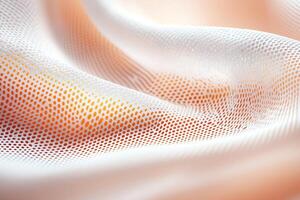 A close-up view of soft, textured fabric that showcases a delicate mesh pattern, blending shades of white and peach, perfect for textile design and fashion industry inspiration. photo