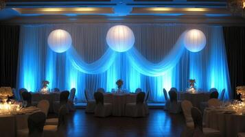 Elegant Wedding Reception Decor with Blue Lighting and Paper Lanterns photo
