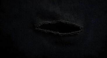 Worn and distressed textile with a large rip, emphasizing texture and depth. Fabric rips texture. photo