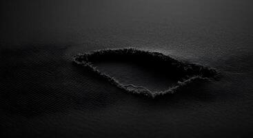 Torn black cloth with frayed threads, creating an edgy and rough aesthetic for backgrounds. Fabric rips texture. photo