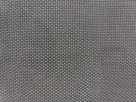 Black speaker surface texture. Macro. Woven mesh surface. metal grille, mesh speaker, dark fabric amplifier part. Speaker grille photo
