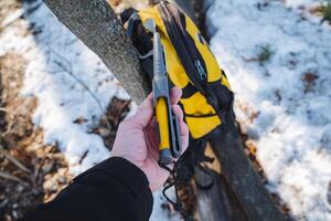 A person is firmly holding a bright yellow and sleek black tool in their hand, showcasing its importance and utility for various activities or tasks they might be involved in photo