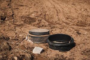 A tall stack of plates balances on an uneven mound of dirt, creating a striking contrast that captures attention and stirs curiosity, urging onlookers to take a closer look photo