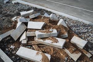 A large pile of bricks, resting on a bed of dirt beneath it, effectively showcases the types of materials that are commonly used in various construction and building projects today photo