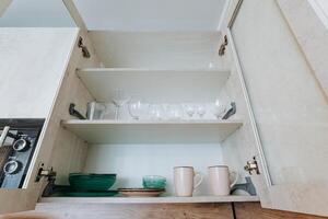 Imagine a wellorganized kitchen cabinet filled with beautifully arranged plates, cups, and glasses for easy access and optimal functionality, enhancing your cooking experience photo