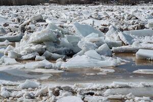 There is a significant and substantial pile of ice that is currently floating on the surface of a body of water, presenting a striking natural phenomenon that evokes thoughts of winter photo