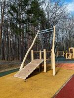 Discover our oneofakind playground design, which includes a unique climbing structure and an exciting swing set, all set beautifully within a natural outdoor environment photo