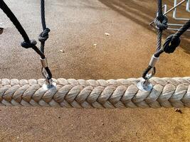 The image shows a closeup of a braided rope with metal connectors and durable black ropes in a tidy workshop, highlighting craftsmanship and versatile applications photo