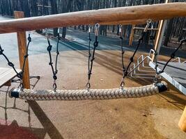 The Adventure Playground features a Rope Climbing Bridge designed specifically for Kids Outdoor Activities, promoting safety while encouraging fun and exploration in nature photo