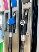 Fuel Pumps located at a Gas Station featuring ColorCoded Nozzle Handles to distinguish between Different Fuel Types for the convenience of consumers and vehicles photo