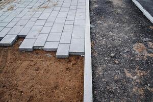 The exquisite newly laid pavers combined with the underlying gravel layer at the bustling construction site reflect modern architectural practices and innovative design solutions photo