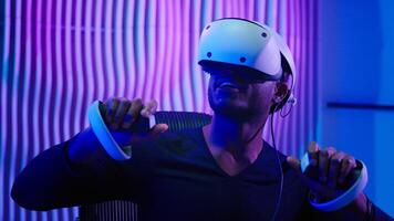 Close up African American gamer user gadget addict modern technology gaming addiction dependency man male guy in cyber futuristic room indoors using VR glasses controllers virtual reality tech helmet photo