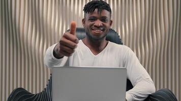 Smiling African American man guy male hacker e-business typing keyboard laptop futuristic cybersecurity coding business online crypto blockchain digital metaverse technology showing thumb up photo