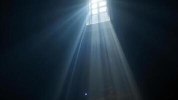 Light Beams Streaming Through Window in Dark Room with Shadows photo