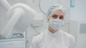 Female dentist adjusting examination light in clinic video