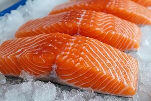 Fresh salmon fillets on ice, showcasing vibrant orange color and distinct patterns, ready for culinary preparation or display. photo