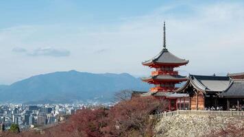 A pagoda in the middle of a city with mountains in the background video