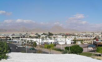 A modern city in Egypt with luxury hotels along the coast, combining the glitz of resort life with the ancient charm photo