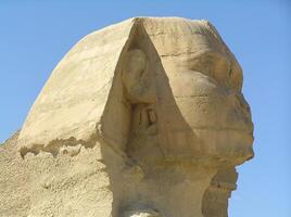 The head of the Sphinx. The legendary Great Sphinx of Giza, carved from limestone, stands majestically against the vast Egyptian desert photo