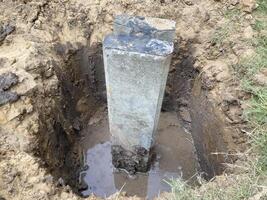 Precast Concrete Digging holes Pile Foundation Installation for building at construction site. photo
