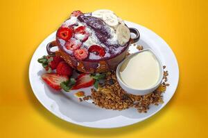 Acai cream with granola, strawberry, banana, condensed .ilk photo