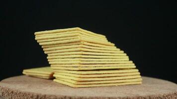 Stack of crispy crackers salted crackers on black background. Rotating display video