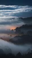 A view of fog rolling over the hills at night photo