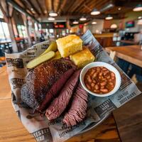 The brisket is served with beans, cornbread and a side of coleslaw photo