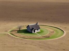 An aerial view of a small house in a circular field photo