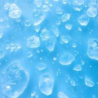 Ice cubes floating in water on a blue background photo