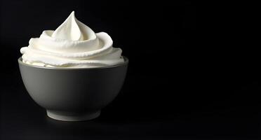 A cup of whipped cream on a black background photo