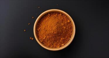 A bowl of spices on a black background photo