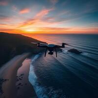 A drone flying over the ocean at sunset photo