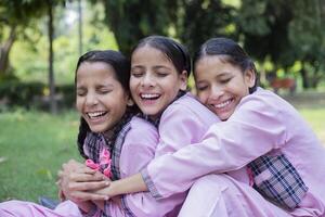 Picture Of Three Smiling Friends Enjoying Break Time At The School Park photo