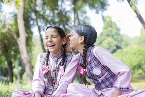 Close Up Image Of A Skillful Girl Student Looking Up While Sitting In The Park photo