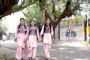 Young Learners Playing In The Park While Going To School photo