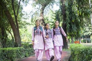 Photoshoot Of Rural One Student Girl In School Dress Standing With Backpack Smiling While Looking At The Camera photo